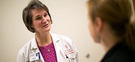 Ann Baggot, APNP, consults with a patient